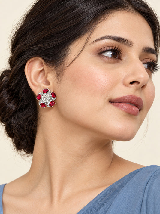 Red Oval Stone Floral Stud Earrings in silver plating worn by a model, close-up