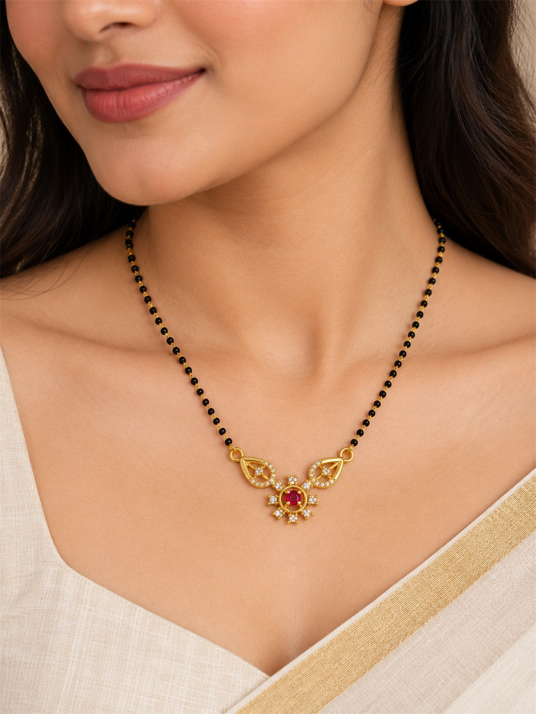Red flower and open leaf gold-plated mangalsutra worn by a model
