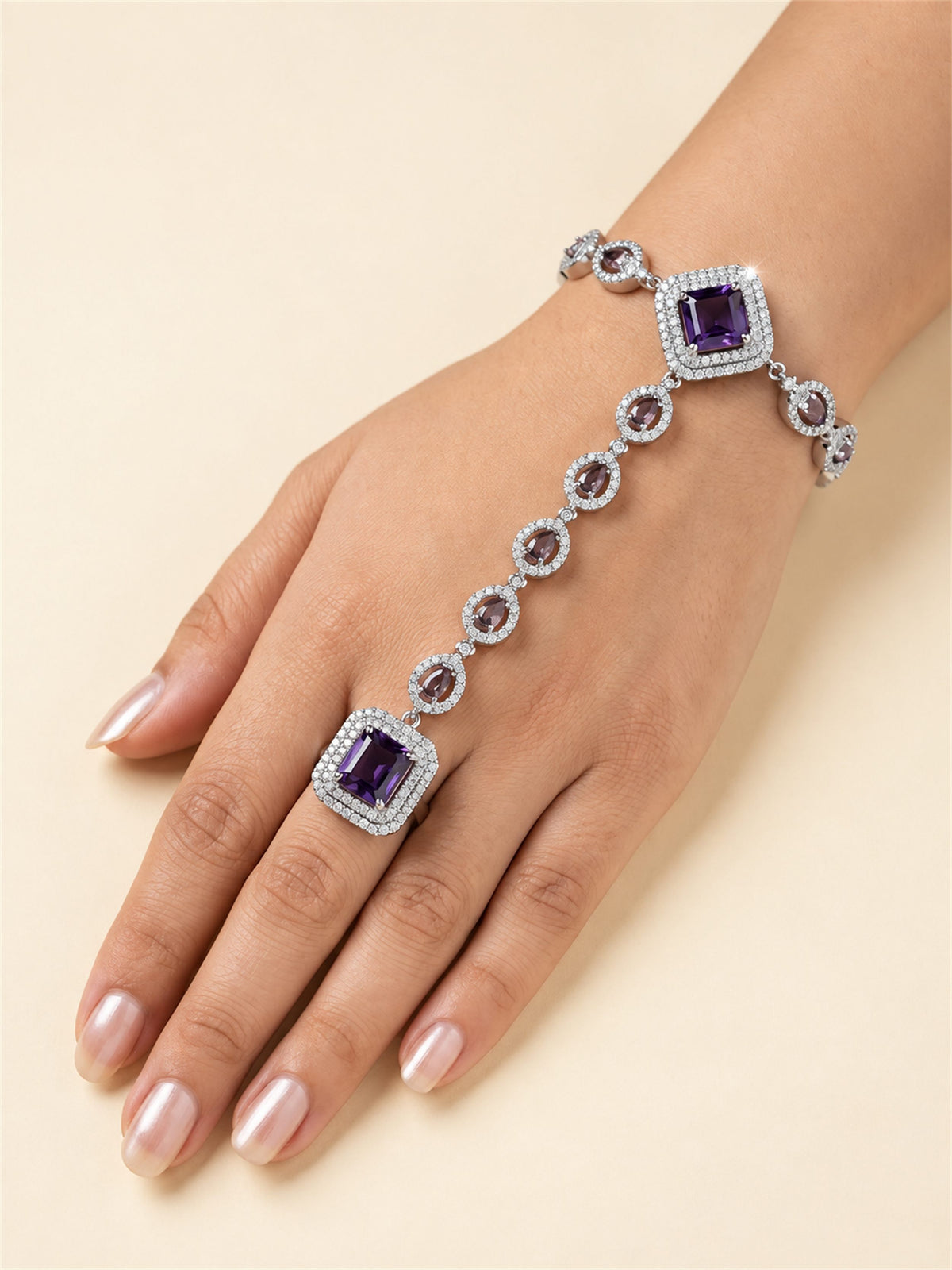 Purple silver-plated square halo and teardrop hathphool worn on hand