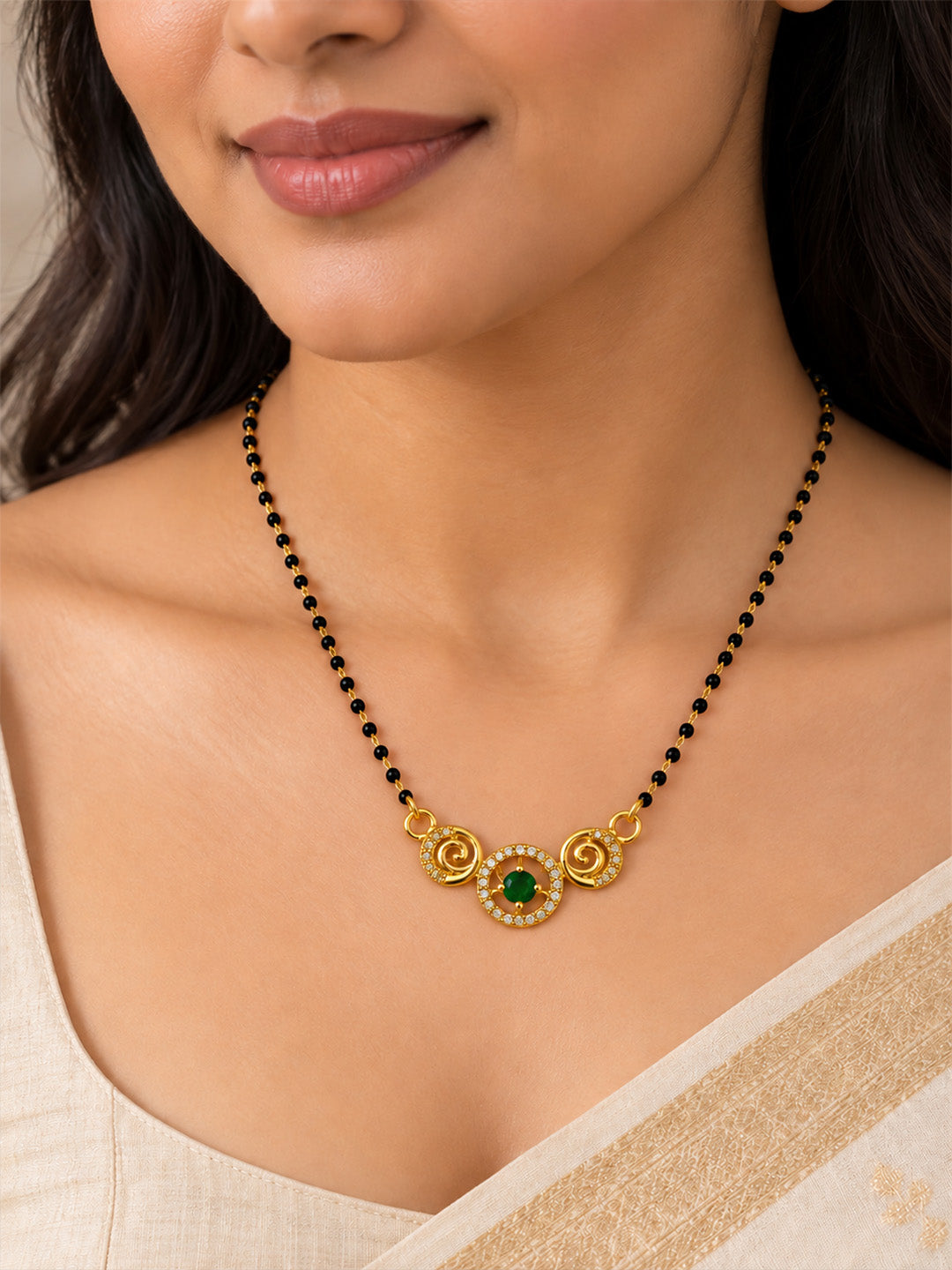 Green round stone and spiral gold-plated mangalsutra worn by a model