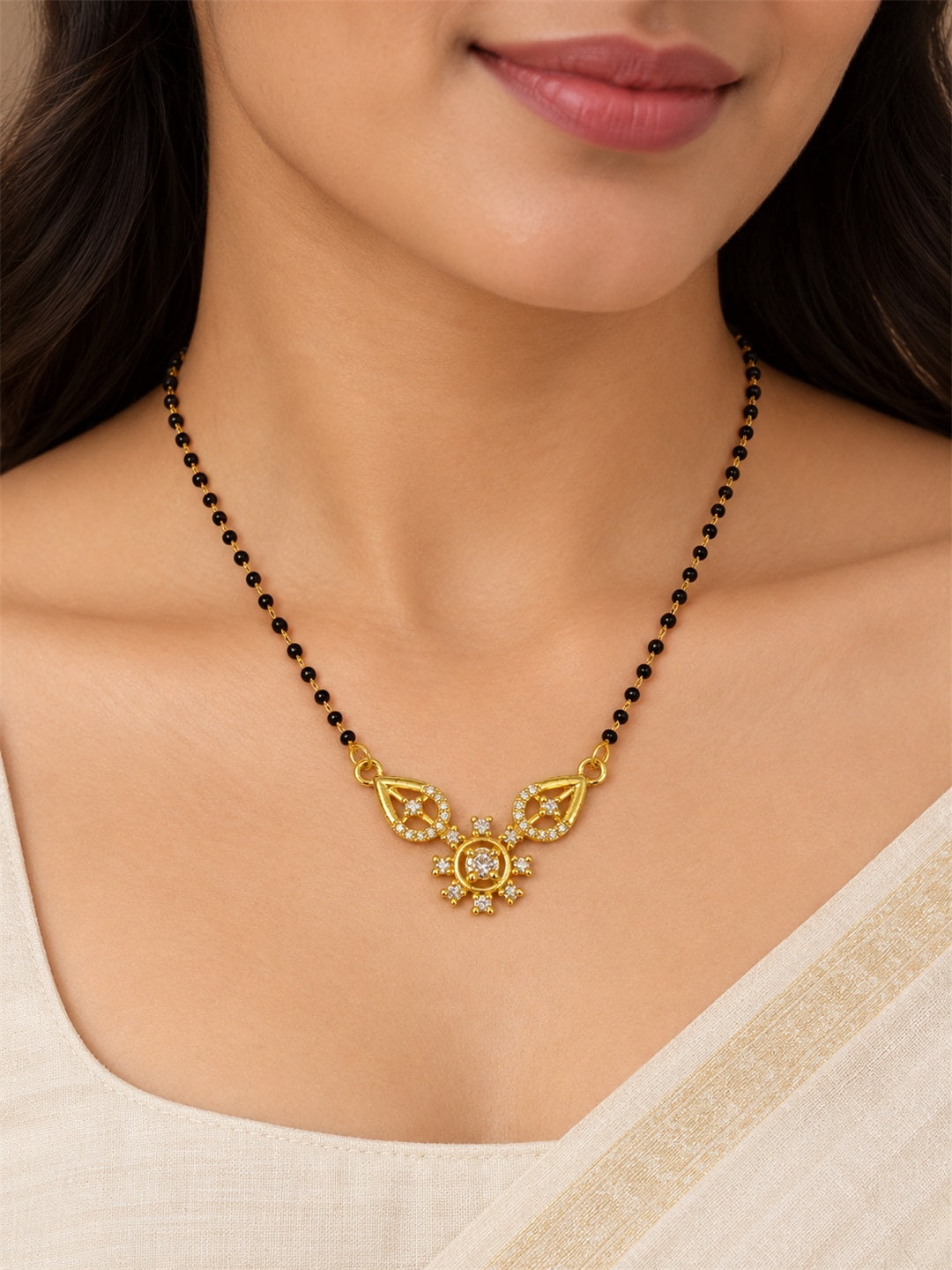 White flower and open leaf gold-plated mangalsutra worn by a model