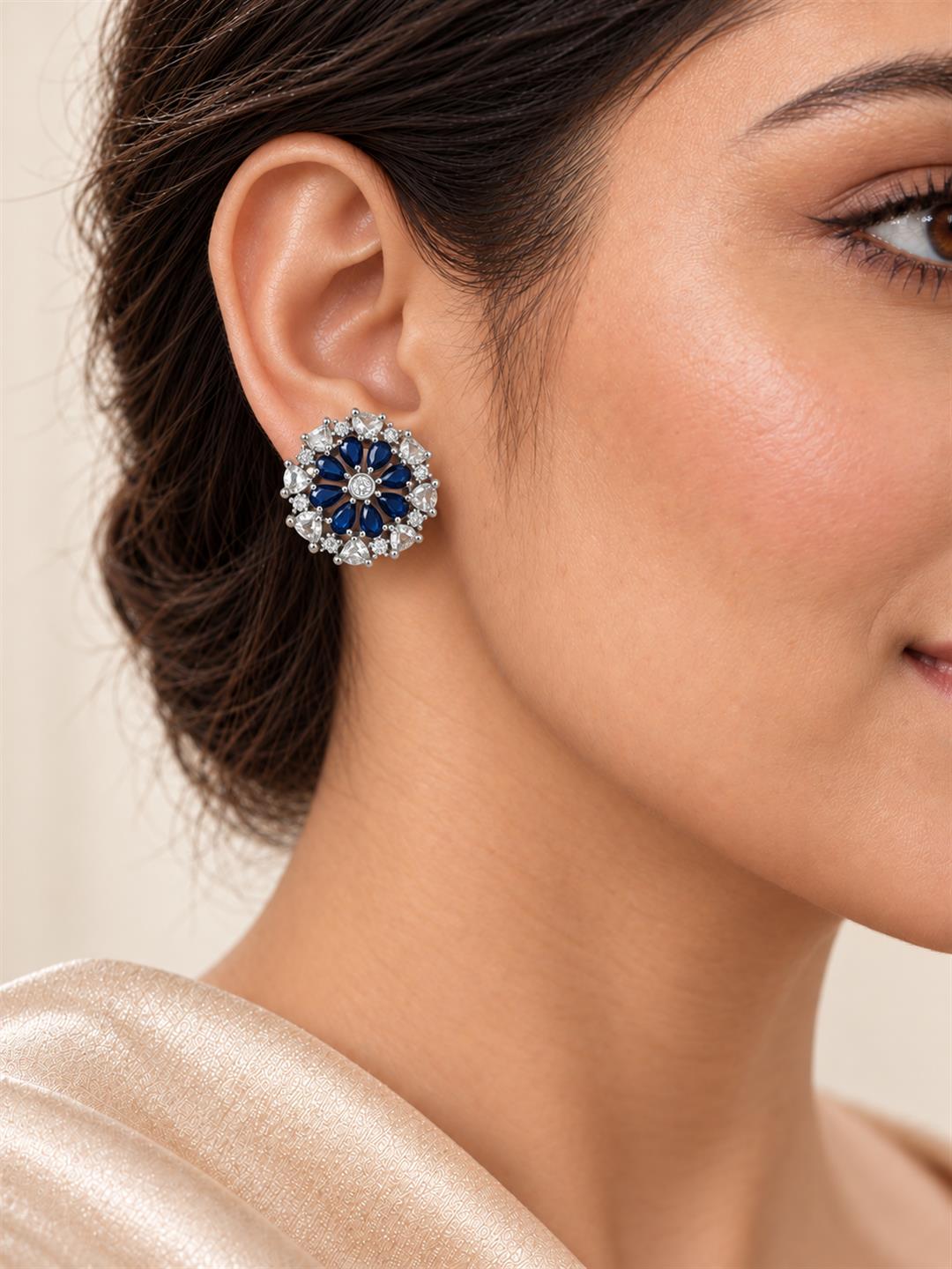 Blue heart-petal flower silver-plated stud earrings worn by a model