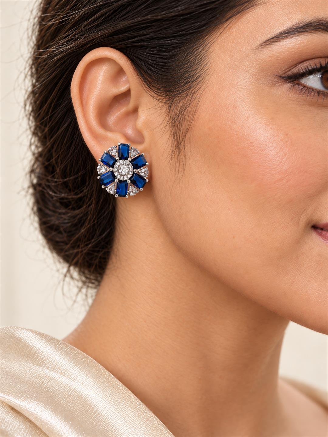 Blue round flower silver-plated stud earrings worn by a model