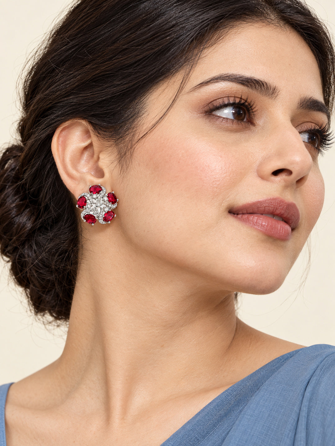 Red Oval Stone Floral Stud Earrings in silver plating worn by a model, close-up