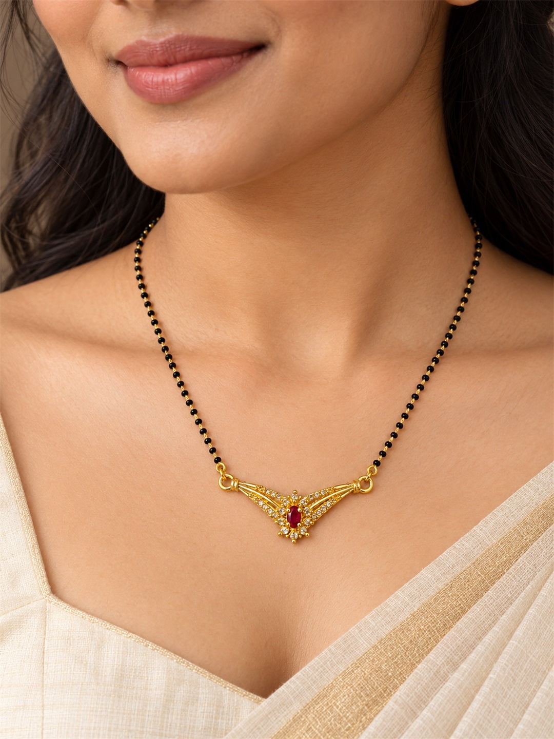Red wing-shaped gold-plated mangalsutra worn by a model