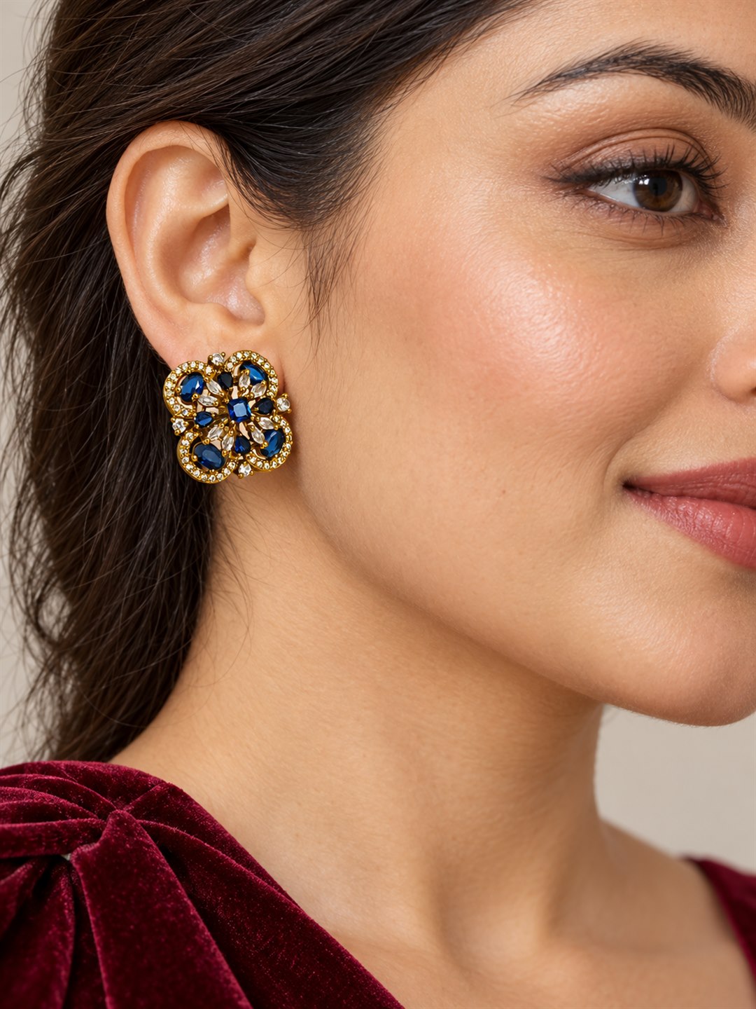 Blue Four Petal Oval Stone Stud Earrings - Gold Plated on a model