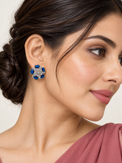 Blue Oval Stone Openwork Floral Stud Earrings in silver plating worn by a model, close-up