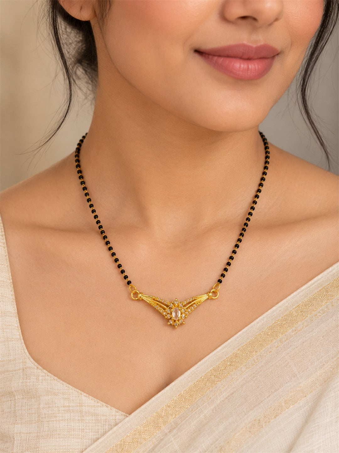 White wing-shaped gold-plated mangalsutra worn by a model